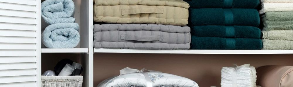 Organized linen closet with neatly folded towels